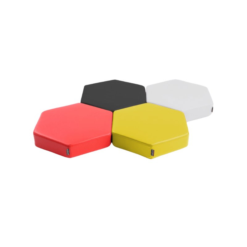 Hive Floor Cushions Set of four Hive Floor Cushions in black, yellow, red, and white colors, designed for comfortable seating on the floor.