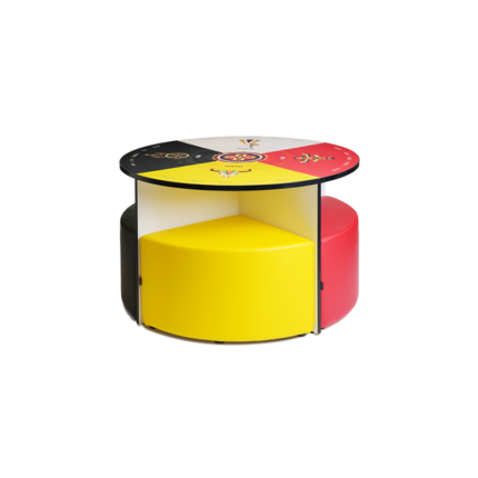 Graphic Medicine Wheel Huddl set, featuring a 48-inch diameter table with a high-pressure laminate design of the Medicine Wheel in colors white, red, yellow, and black. Soft seating in matching colors nests neatly beneath the table, optimizing space. The table stands at 29 inches high, while the seats are 18 inches high with 3-inch high-density foam cushions upholstered in durable, fire-retardant vinyl